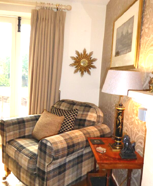 Upholstered-tartan-armchair-with-complementing-cushions
